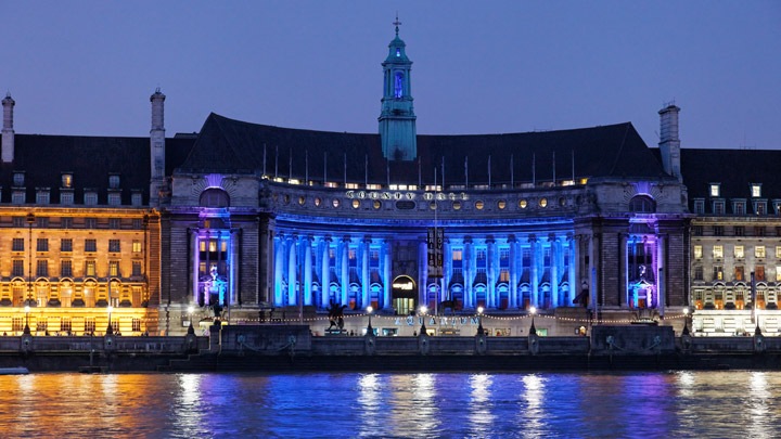 Modern building, brilliantly illuminated with red and blue fa&ccedil;ade lighting