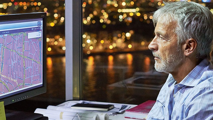 A city planner manages a connected lighting system on his computer - smart street lighting system