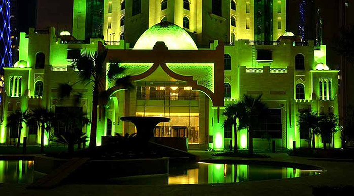The façade of Al Jassimiya tower illuminated with Philips green lighting 