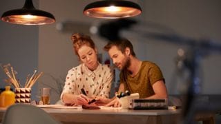 Two people creating a light plan at a well lit desk