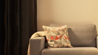 "Cosy living room with modern LED table lamp, illuminating grey loveseat and creating warm ambiance for home relaxation."